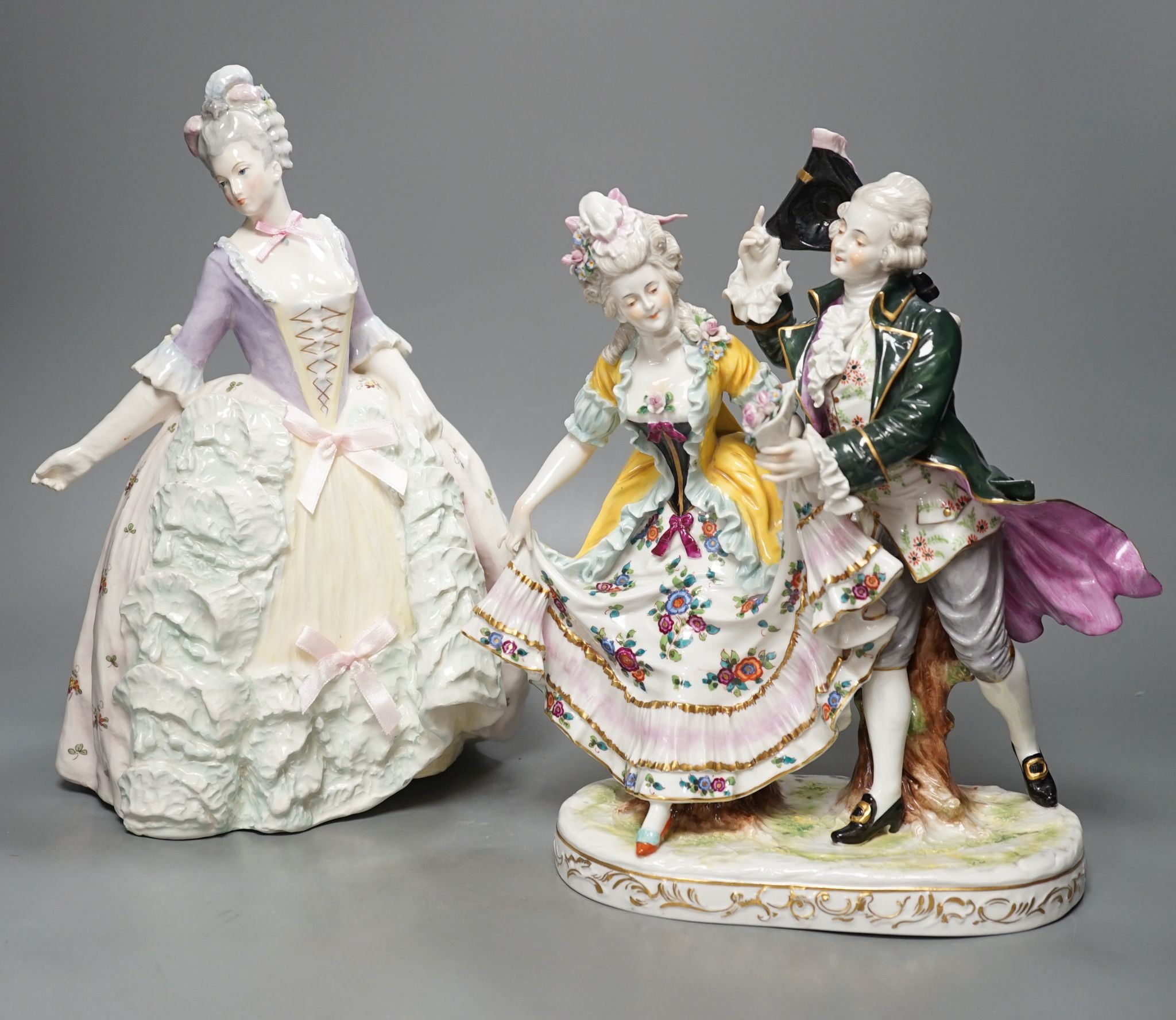 An Italian porcelain group of a dancing couple, 31cm, and an Italian maiolica figure of a lady